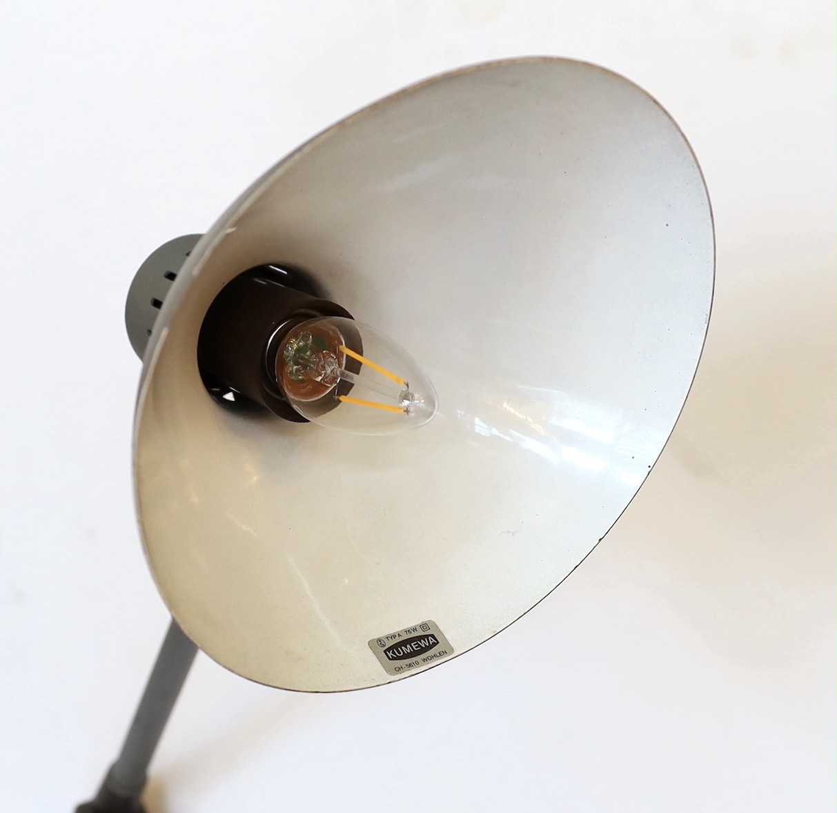 A 1950s Swiss enamelled and painted metal anglepoise lamp, height 56cm to the bend